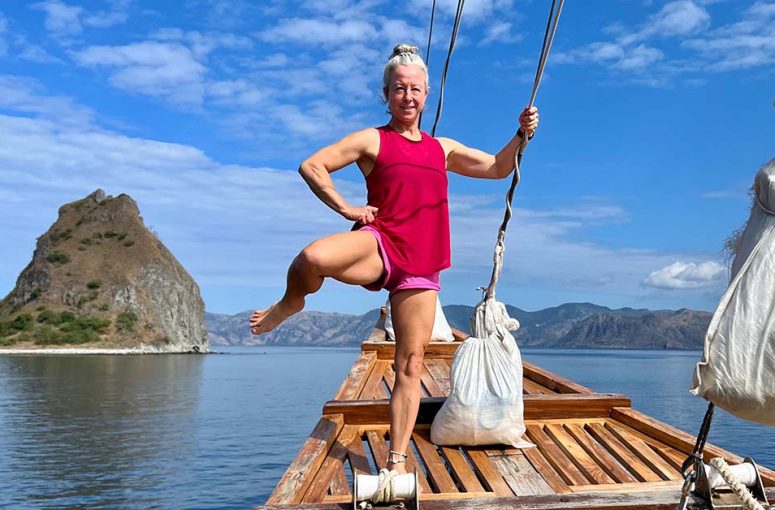 Woman doing controlled articular rotation to improve her joints mobility on a boat