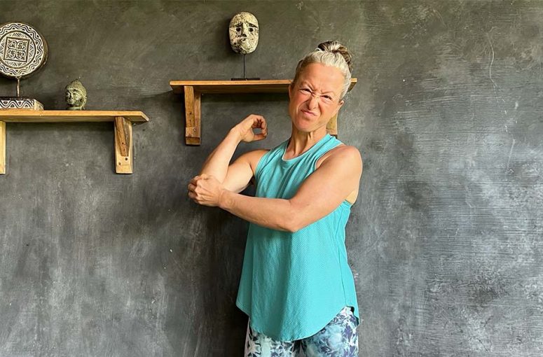 Woman point at her painful elbow.