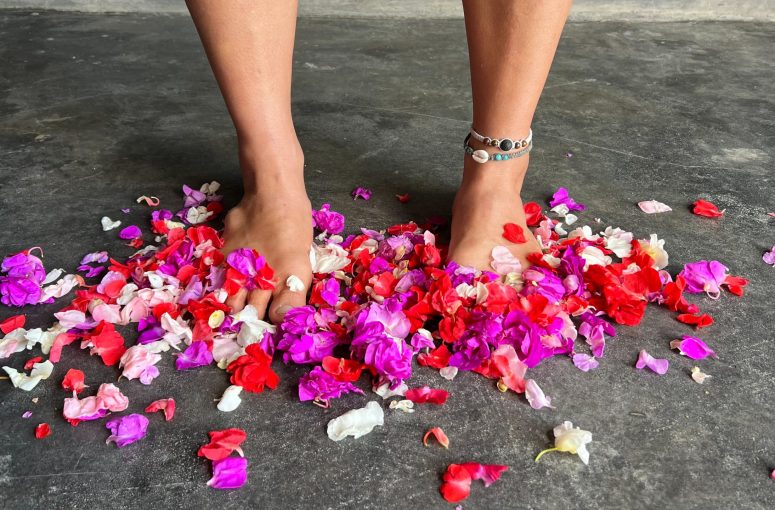 Happy healthy feet surrounded by flower petals.